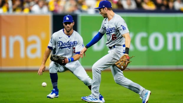 Dodgers shortstop Trea Turner goes for the baseball after dropping a popup against the Padres.